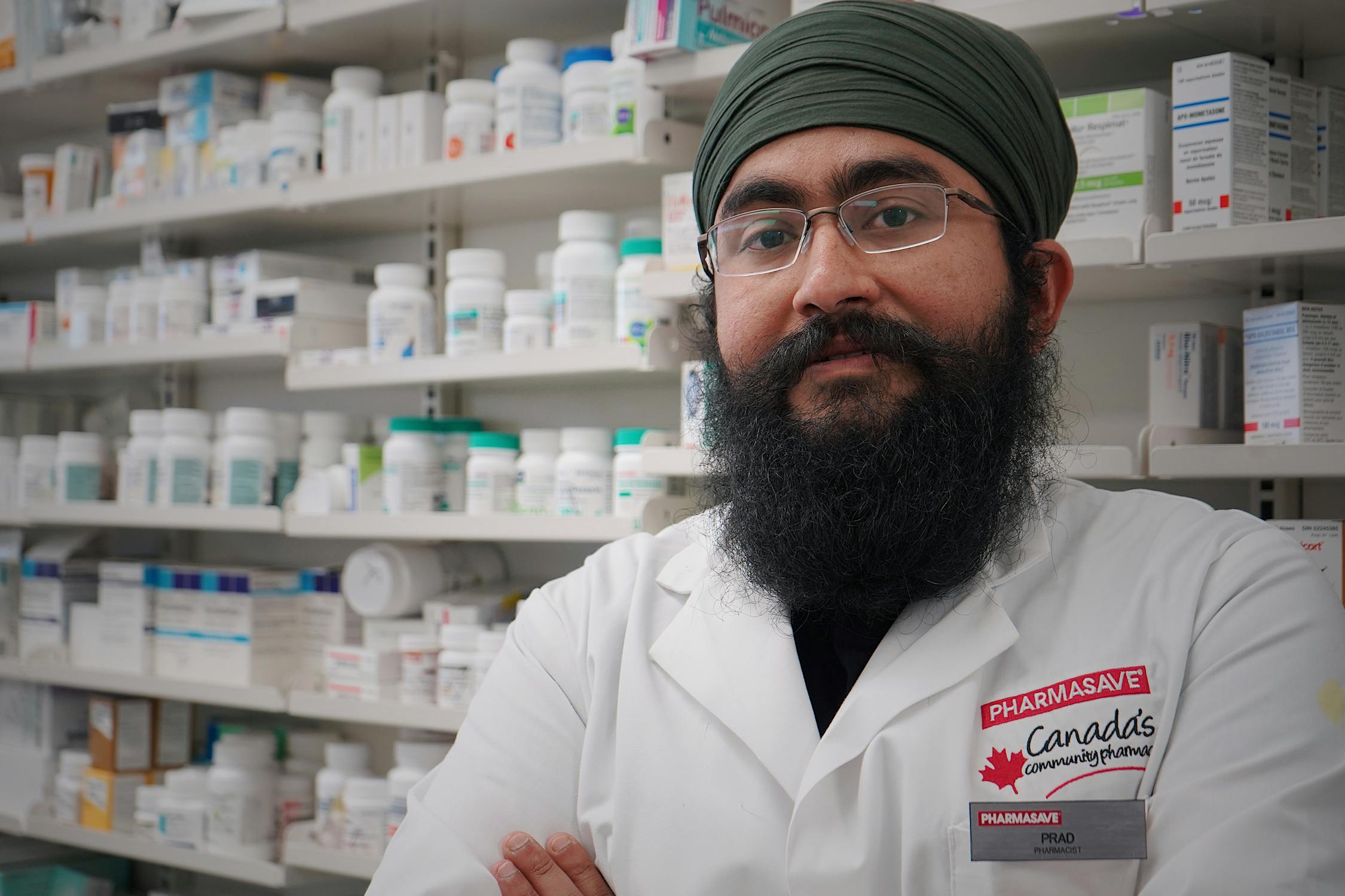 Pharmacist checking medication on pharmacy shelves